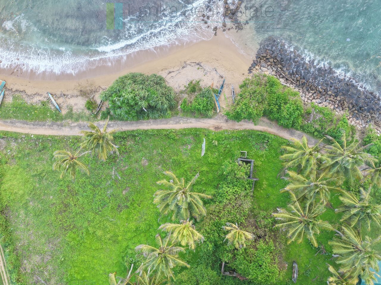 Ocean-facing palm-fringed land in Kottagoda