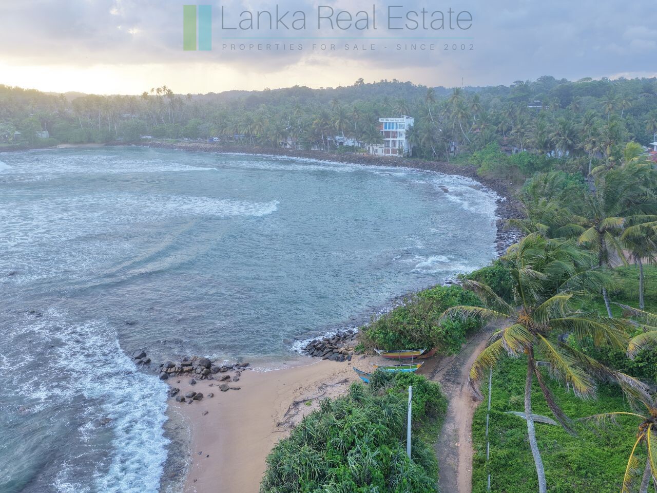 Ocean-facing palm-fringed land in Kottagoda