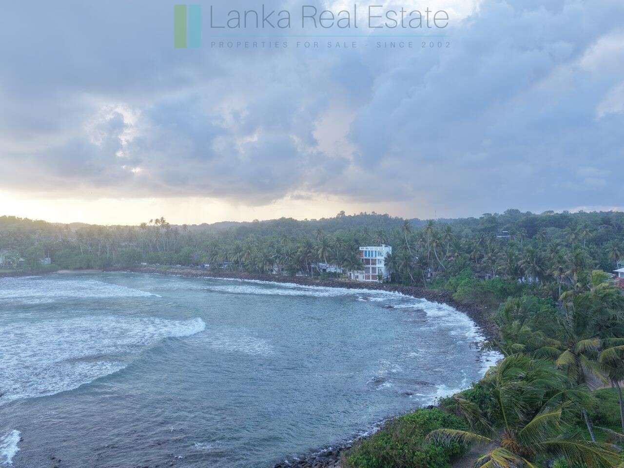 Ocean-facing palm-fringed land in Kottagoda